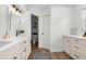 Bathroom with dual sinks, quartz countertops, wood-look tile, and a private toilet room at 11227 Lakeview Dr, New Port Richey, FL 34654