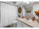 Well-lit bathroom with single sink and decorative woven wall decor at 11227 Lakeview Dr, New Port Richey, FL 34654