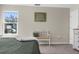 Bedroom view of a window, decorative wall art, and bench seating at 11227 Lakeview Dr, New Port Richey, FL 34654