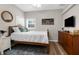 Cozy bedroom featuring wood floors, ceiling fan, large bed, and tasteful decorations at 11227 Lakeview Dr, New Port Richey, FL 34654