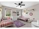 Shared bedroom with two twin beds and large windows at 11227 Lakeview Dr, New Port Richey, FL 34654