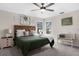 Bedroom with decorative wall art, large windows, ceiling fan, bench, and wooden headboard at 11227 Lakeview Dr, New Port Richey, FL 34654