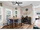 Bright breakfast nook with large windows, a rustic wooden table, and natural light at 11227 Lakeview Dr, New Port Richey, FL 34654