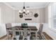 Charming dining room with stylish chandelier, wainscoting, and ample natural light for Gathering gatherings at 11227 Lakeview Dr, New Port Richey, FL 34654