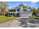 Beautiful two-story home featuring a spacious driveway and a welcoming front porch at 11227 Lakeview Dr, New Port Richey, FL 34654
