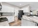 Stylish kitchen with white cabinets, granite countertops, and modern appliances for easy meals at 11227 Lakeview Dr, New Port Richey, FL 34654