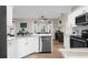 Open kitchen featuring granite countertops, stainless steel appliances, and a view of the dining area at 11227 Lakeview Dr, New Port Richey, FL 34654