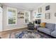 Sunlit playroom with large windows, a cozy chair, and a fun, colorful decor at 11227 Lakeview Dr, New Port Richey, FL 34654
