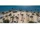 Stunning coastal aerial view of sandy beach with palm trees, clear water, and recreational area, great for relaxation and fun at 120 Read St, Tarpon Springs, FL 34689