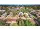 Aerial view of a charming neighborhood with mature trees and a red brick street at 120 Read St, Tarpon Springs, FL 34689