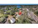 Aerial view of the property surrounded by lush trees near a waterfront community at 120 Read St, Tarpon Springs, FL 34689