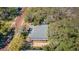 Aerial view of the home showcasing its roof, backyard, and prime location on a tree-lined street at 120 Read St, Tarpon Springs, FL 34689