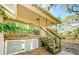 Backyard and covered porch view with wooden stairs and white lattice decoration at 120 Read St, Tarpon Springs, FL 34689
