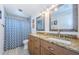 Bathroom featuring double sinks, granite countertops, and a shower-tub combo at 120 Read St, Tarpon Springs, FL 34689