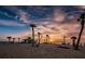 Picturesque sunset view of sandy beach with palm trees creating a serene atmosphere and perfect retreat for tranquility at 120 Read St, Tarpon Springs, FL 34689