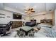 Bedroom with ceiling fan, gray walls, wood-look tile, and a large dresser at 120 Read St, Tarpon Springs, FL 34689