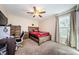 Bedroom with carpeted floors, window, ceiling fan, and wood furnishings at 120 Read St, Tarpon Springs, FL 34689