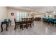 Open-concept dining room with wood-look floors, a large table, and views into the living room at 120 Read St, Tarpon Springs, FL 34689