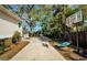Large driveway with a basketball hoop, swing and greenery, perfect for a Gathering to enjoy at 120 Read St, Tarpon Springs, FL 34689