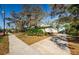 Charming exterior of the home, showcasing its unique design and lush landscaping at 120 Read St, Tarpon Springs, FL 34689