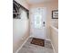 Inviting foyer features a decorative front door, tiled floors, and stylish decor, creating a warm welcome at 120 Read St, Tarpon Springs, FL 34689