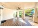 Expansive front porch with wooden flooring and railings, offering a comfortable and shaded outdoor space at 120 Read St, Tarpon Springs, FL 34689