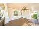 Covered front porch features wooden flooring, a ceiling fan, and a view of the neighborhood, enhancing the home's curb appeal at 120 Read St, Tarpon Springs, FL 34689