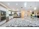 Bright kitchen with granite countertops, stainless steel appliances, and a spacious center island with pendant lights at 120 Read St, Tarpon Springs, FL 34689