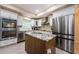 Contemporary kitchen featuring a center island, stainless steel appliances, and ample cabinet space at 120 Read St, Tarpon Springs, FL 34689