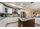 Modern kitchen with white cabinetry, a granite island, stainless steel appliances, and wood look flooring at 120 Read St, Tarpon Springs, FL 34689