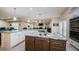 Gourmet kitchen featuring a large island, granite countertops, stainless appliances, and open layout at 120 Read St, Tarpon Springs, FL 34689