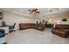 Open concept living room flowing into a dining area and kitchen with wood-look tile at 120 Read St, Tarpon Springs, FL 34689