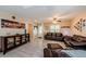 Cozy living room featuring comfortable seating, a decorative cabinet, and wood-look floors, creating an inviting atmosphere at 120 Read St, Tarpon Springs, FL 34689
