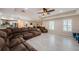 Open floor plan living room with wood-look floors, ceiling fan, and bright neutral walls at 120 Read St, Tarpon Springs, FL 34689