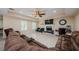Bright living room with white wood-look tile, fireplace, ceiling fan, and light neutral walls at 120 Read St, Tarpon Springs, FL 34689