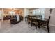 Open-concept living and dining area with wood-look flooring, seamlessly blending comfort and style for entertaining at 120 Read St, Tarpon Springs, FL 34689
