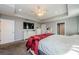 The main bedroom offers gray walls, a tray ceiling with a ceiling fan, and white dressers with a mounted tv at 120 Read St, Tarpon Springs, FL 34689