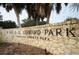 Stone sign reading 'Fred H. Howard Park' with palm trees, inviting visitors to a scenic destination at 120 Read St, Tarpon Springs, FL 34689