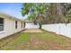 Fenced backyard featuring a stone patio area and ample space for outdoor activities and entertainment at 12112 Shearwater Dr, New Port Richey, FL 34654