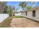 Large backyard with a stone patio, a white fence, and partial grass; perfect for outdoor living at 12112 Shearwater Dr, New Port Richey, FL 34654
