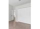Bedroom with neutral colored tile and view into the kitchen at 12112 Shearwater Dr, New Port Richey, FL 34654