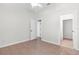 Spacious bedroom with neutral tones, tile floor and ceiling fan at 12112 Shearwater Dr, New Port Richey, FL 34654