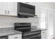 Modern kitchen featuring new range and LG microwave at 12112 Shearwater Dr, New Port Richey, FL 34654
