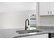 A sleek black sink complements the granite countertop in this bright, modern kitchen at 12112 Shearwater Dr, New Port Richey, FL 34654