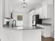 Modern kitchen featuring granite countertops, white cabinets and a stainless steel sink at 12112 Shearwater Dr, New Port Richey, FL 34654