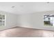 Bright living room featuring tile floors, neutral walls, and ample natural light from the windows at 12112 Shearwater Dr, New Port Richey, FL 34654