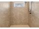 Walk-in shower with beige tile and rainfall shower head at 12112 Shearwater Dr, New Port Richey, FL 34654