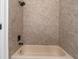 Tiled shower with a neutral color and a rain shower head at 12112 Shearwater Dr, New Port Richey, FL 34654