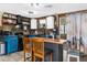 A charming kitchen featuring a butcher block island, wood paneled walls, and ample natural light at 12420 Lacey Dr, New Port Richey, FL 34654