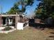 Spacious backyard featuring a covered patio area and mature trees at 12716 Mulberry Ln, Hudson, FL 34667